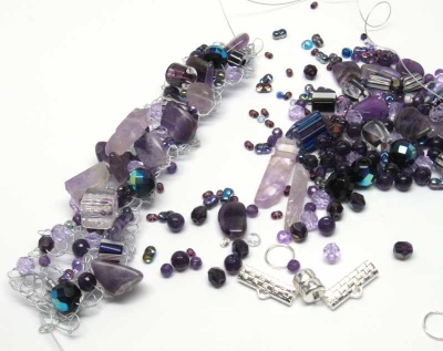 This photo shows the assortment of beads and findings that go into this kit, plus on the left, the bracelet in-progress. The beads in your kits will vary but give this overall look.